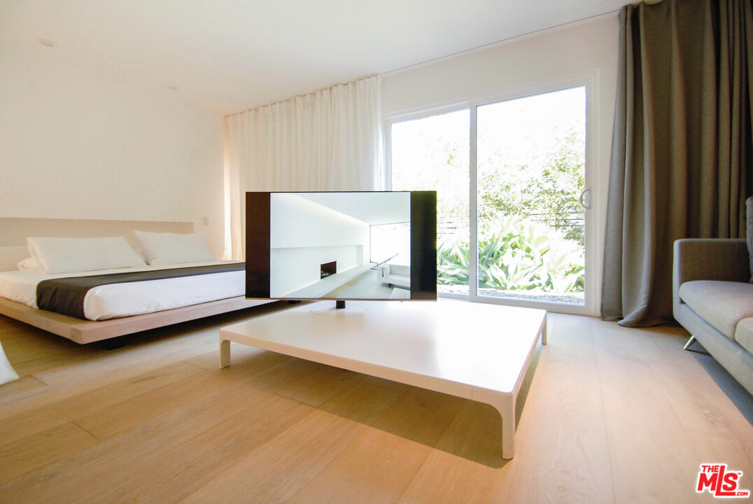 Undisclosed Address Los Angeles, CA 90064 - Photo 21 of 25 a living room with a bed and a couch next to a window