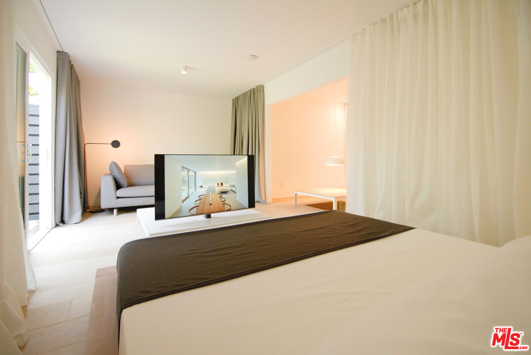 Undisclosed Address Los Angeles, CA 90064 - Photo 22 of 25 a bedroom with a bed and wooden floor