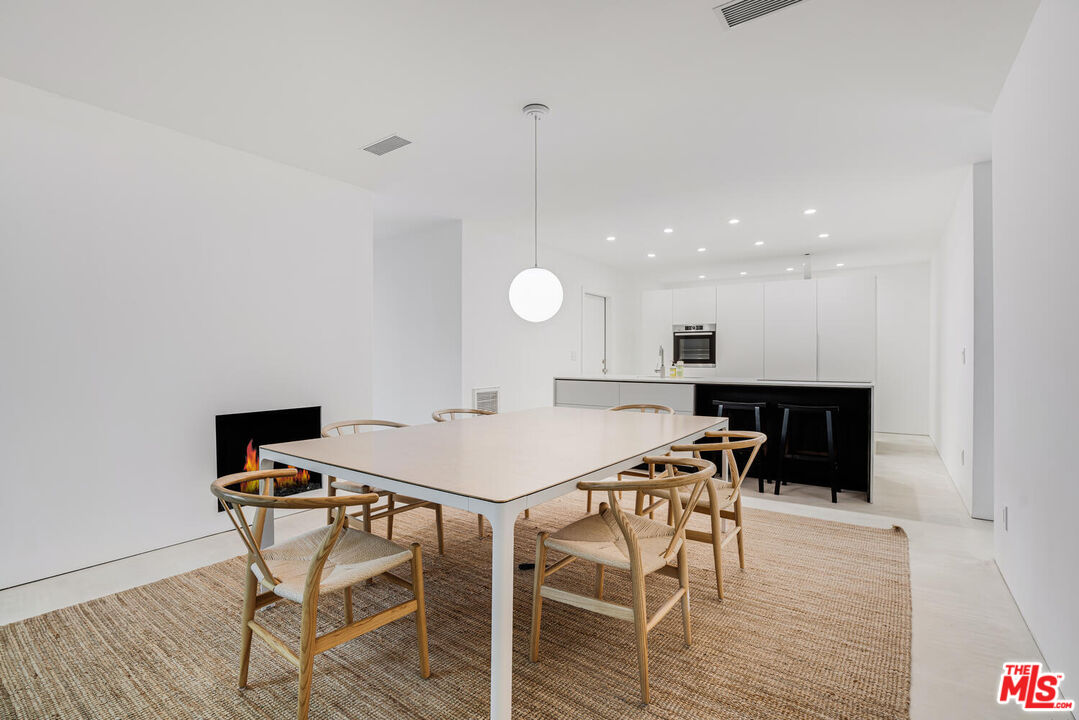 Undisclosed Address Los Angeles, CA 90064 - Photo 5 of 25 a kitchen with a table and chairs in it