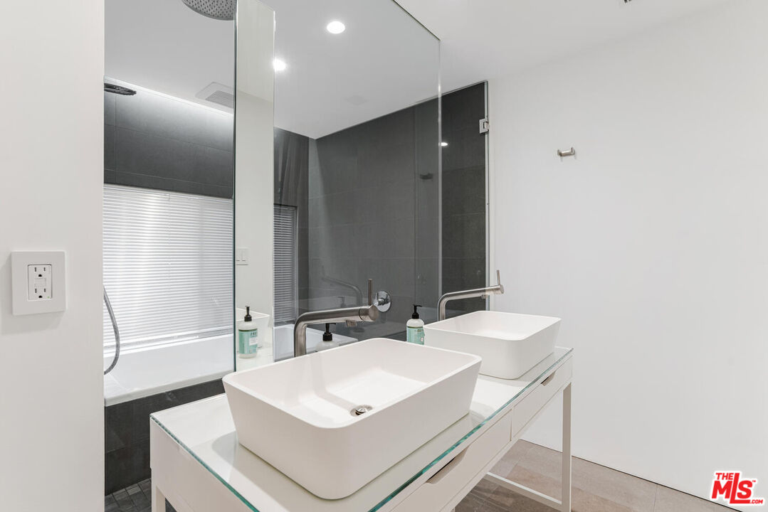 Undisclosed Address Los Angeles, CA 90064 - Photo 9 of 25 a bathroom with a sink a mirror and a shower