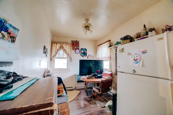 a room with furniture a rug and a refrigerator