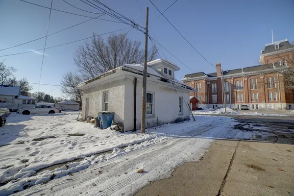 a view of a house with a snow in the yard