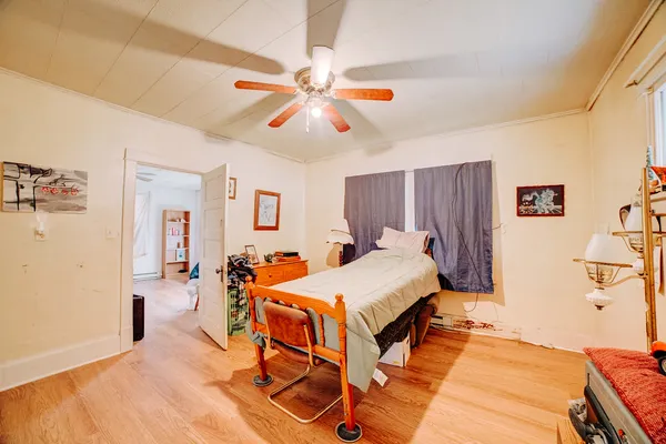 a bedroom with a bed and a chandelier