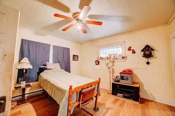 a bedroom with a bed and a chandelier