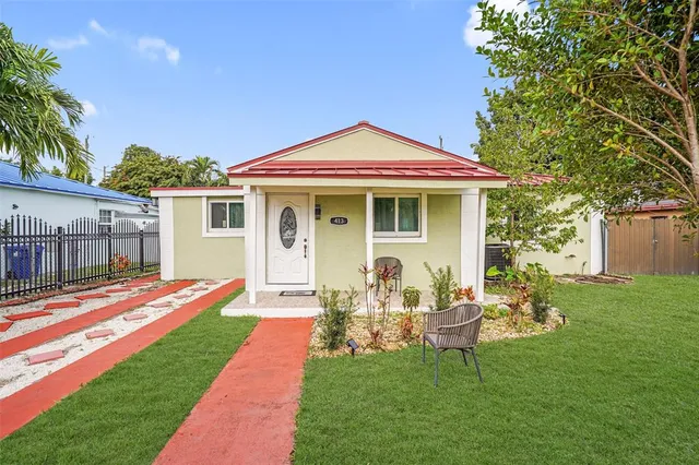 a backyard of a house with table and chairs