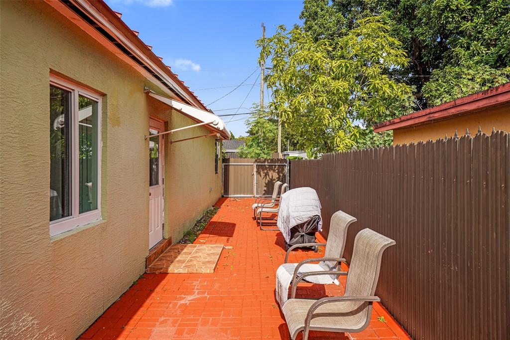 413 Northwest 100th Terrace Miami, FL 33150 - Photo 17 of 29 a backyard of a house with table and chairs