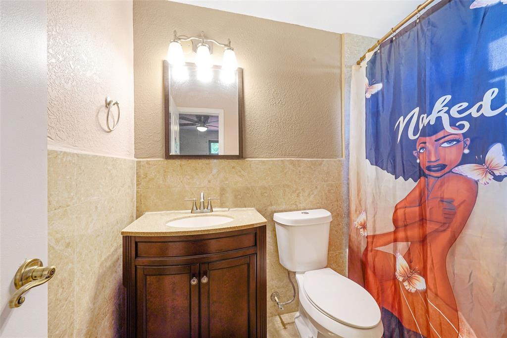 413 Northwest 100th Terrace Miami, FL 33150 - Photo 19 of 29 a bathroom with a toilet sink and mirror