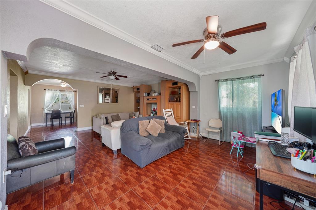 413 Northwest 100th Terrace Miami, FL 33150 - Photo 23 of 29 a living room with furniture and a flat screen tv