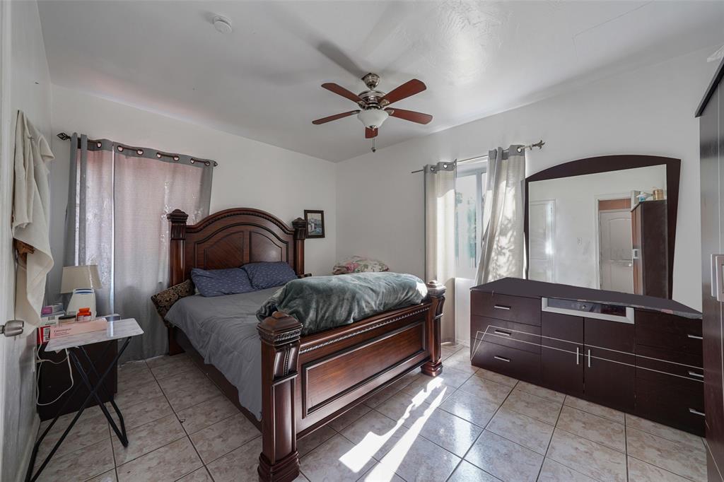 413 Northwest 100th Terrace Miami, FL 33150 - Photo 26 of 29 a bedroom with a bed and wooden floor