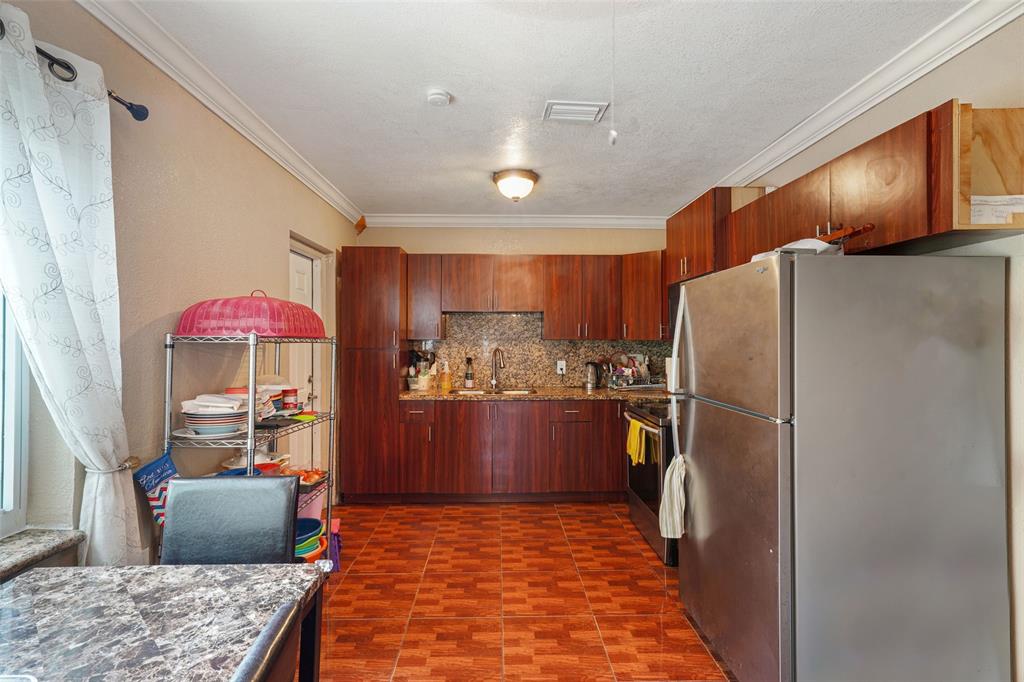 413 Northwest 100th Terrace Miami, FL 33150 - Photo 5 of 29 a kitchen with stainless steel appliances granite countertop a refrigerator and a stove