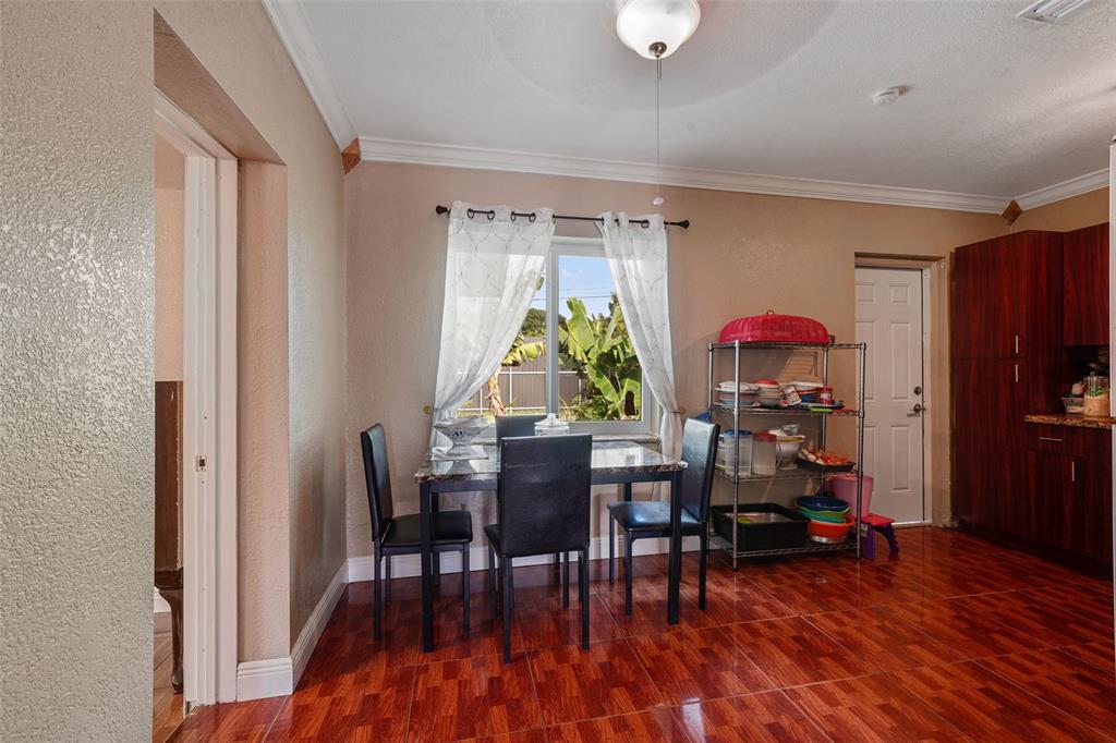 413 Northwest 100th Terrace Miami, FL 33150 - Photo 7 of 29 a view of a dining room with furniture window and wooden floor
