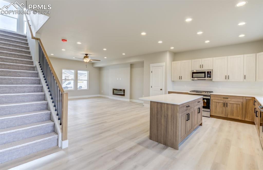 205 High Meadows Drive Florence, CO 81226 - Photo 19 of 49 a large kitchen with stainless steel appliances granite countertop a lot of counter space and wooden floors