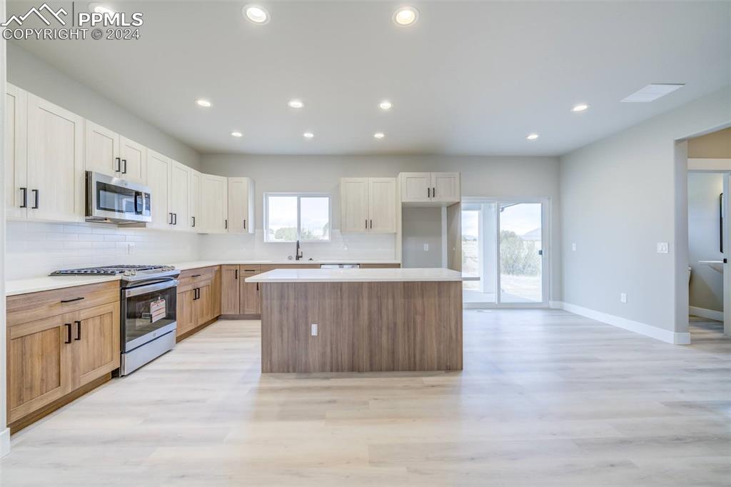 205 High Meadows Drive Florence, CO 81226 - Photo 2 of 49 a large kitchen with stainless steel appliances granite countertop a large counter top a sink and a stove