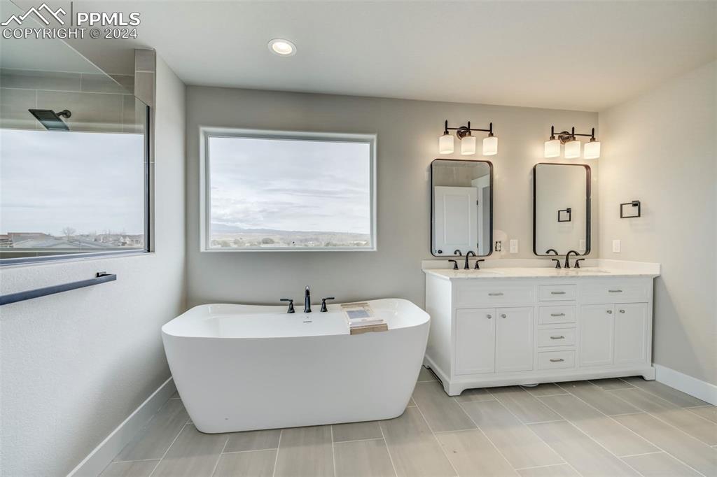 205 High Meadows Drive Florence, CO 81226 - Photo 25 of 49 a bathroom with a double vanity sink mirror and bathtub