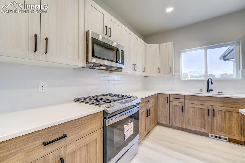 205 High Meadows Drive Florence, CO 81226 - Photo 3 of 49 a kitchen with stainless steel appliances granite countertop white cabinets a sink and dishwasher