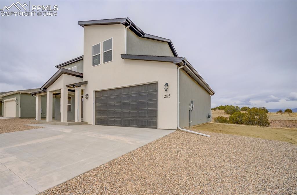 205 High Meadows Drive Florence, CO 81226 - Photo 42 of 49 a view of a house with a garage