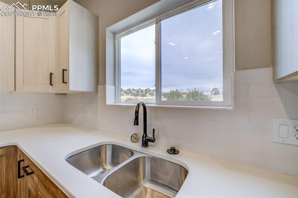 205 High Meadows Drive Florence, CO 81226 - Photo 8 of 49 a kitchen with a sink and a window