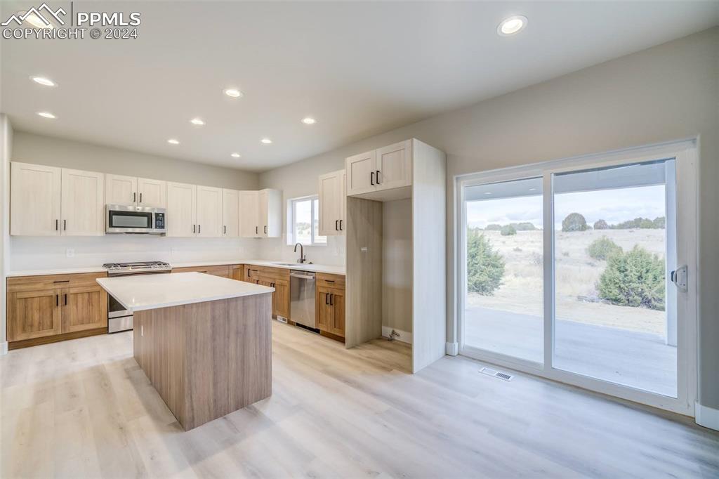 205 High Meadows Drive Florence, CO 81226 - Photo 10 of 49 a large kitchen with stainless steel appliances granite countertop a large counter top and a wooden floors