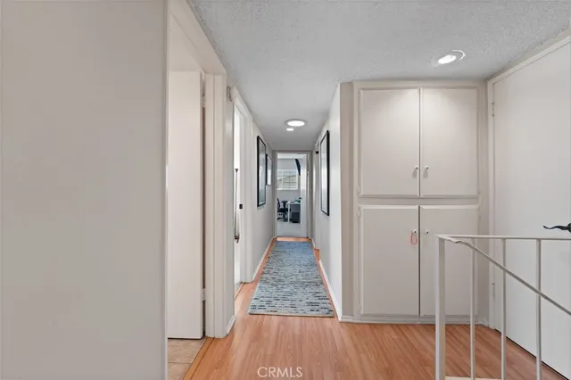 a view of a hallway with wooden floor