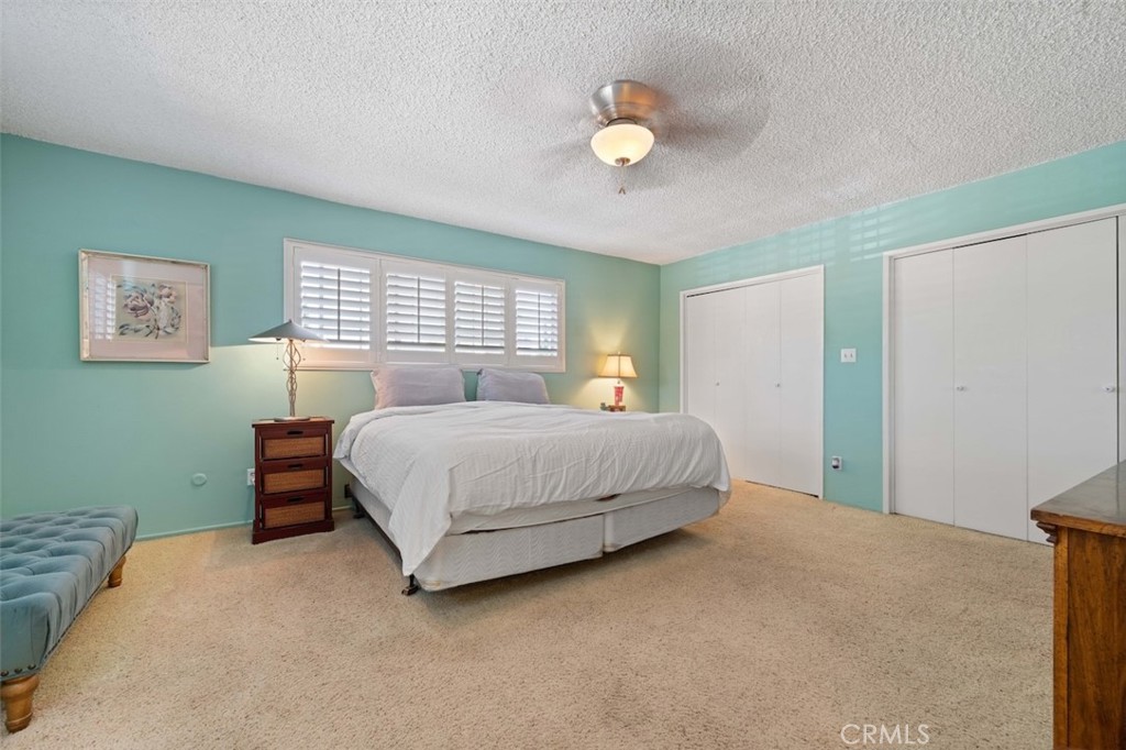 15410 Runnymede Street Van Nuys, CA 91406 - Photo 16 of 22 a bedroom with a bed and painting on the wall
