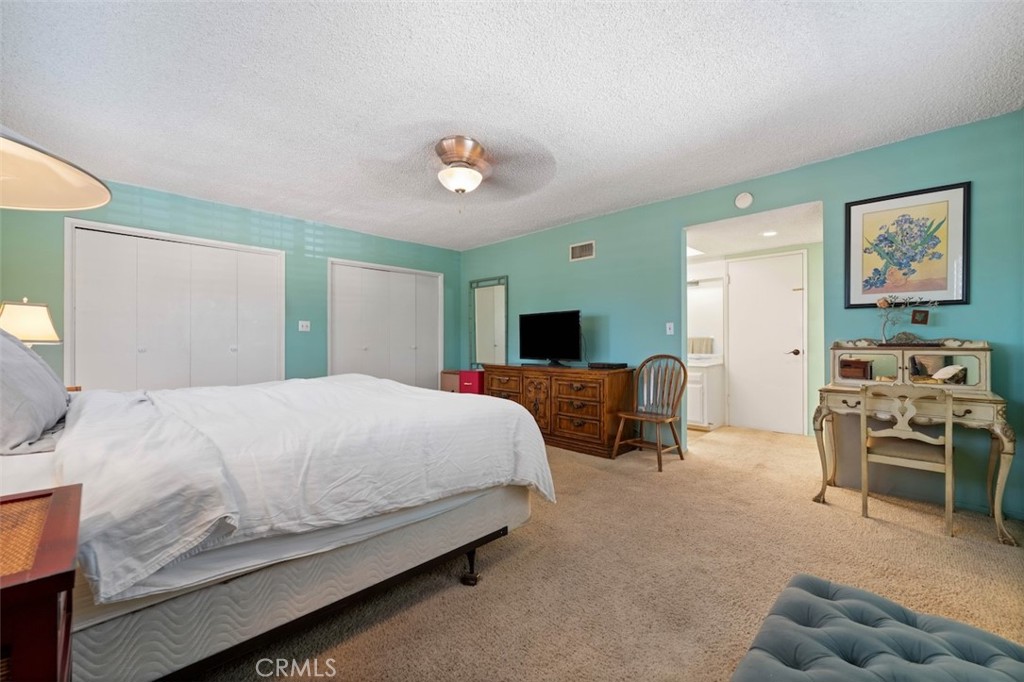 15410 Runnymede Street Van Nuys, CA 91406 - Photo 17 of 22 a spacious bedroom with a bed and a couch