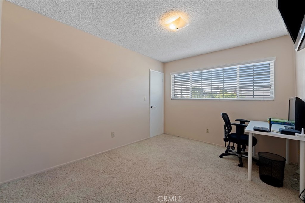 15410 Runnymede Street Van Nuys, CA 91406 - Photo 20 of 22 a view of a workspace with furniture and a window