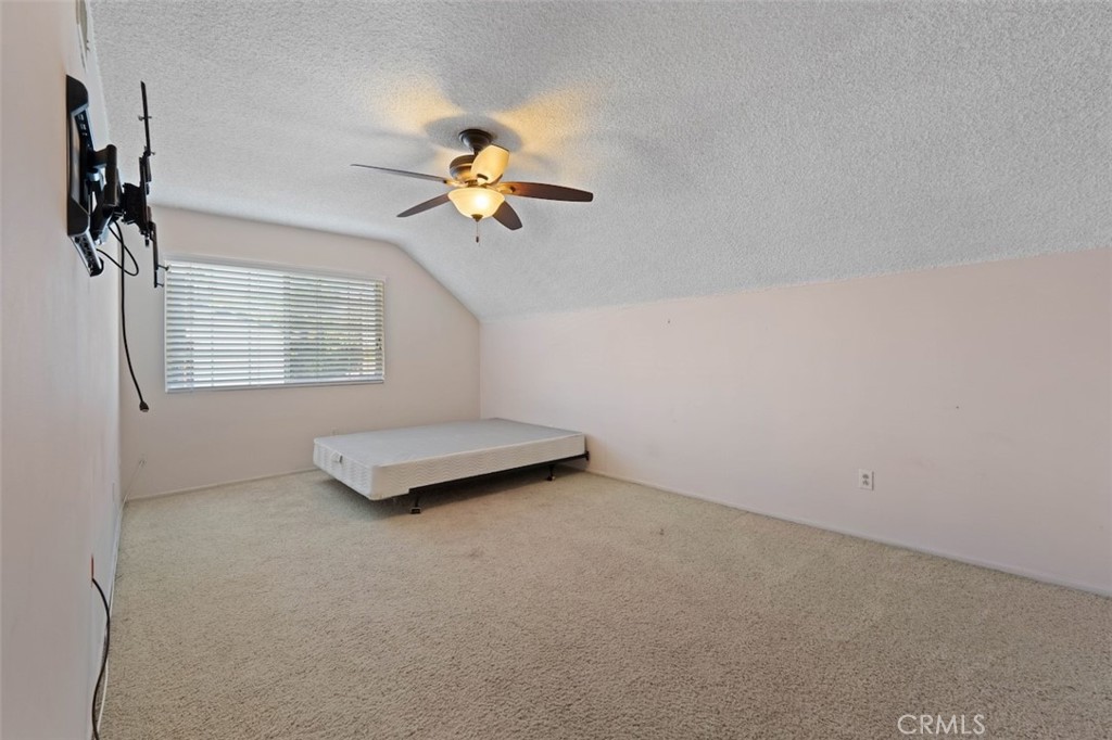 15410 Runnymede Street Van Nuys, CA 91406 - Photo 21 of 22 an empty room with windows and chandelier fan