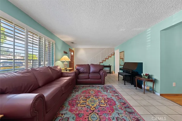 a living room with furniture and a rug