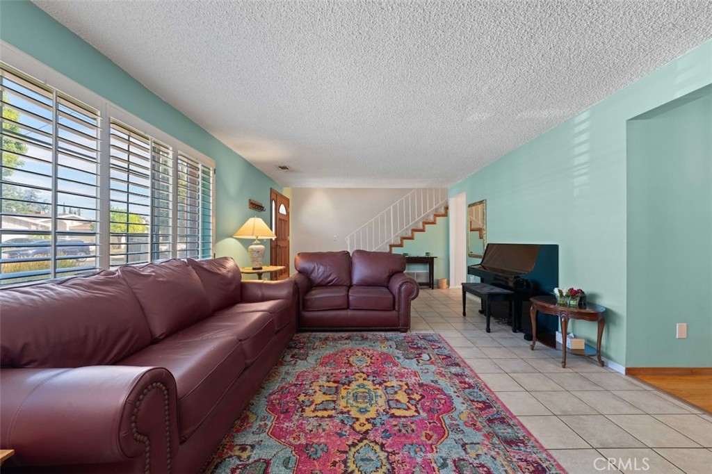 15410 Runnymede Street Van Nuys, CA 91406 - Photo 5 of 22 a living room with furniture and a rug