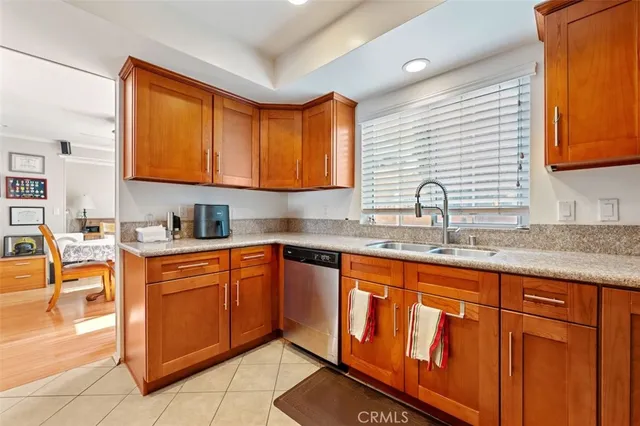 a kitchen with stainless steel appliances granite countertop a sink and cabinets