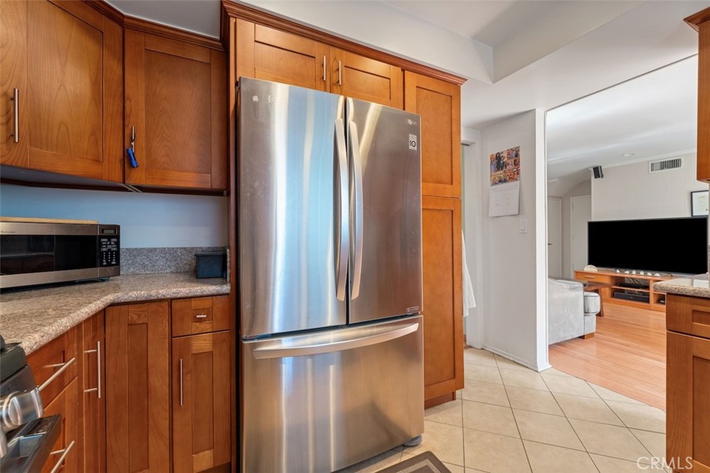15410 Runnymede Street Van Nuys, CA 91406 - Photo 10 of 22 a kitchen with stainless steel appliances granite countertop a refrigerator and a stove top oven