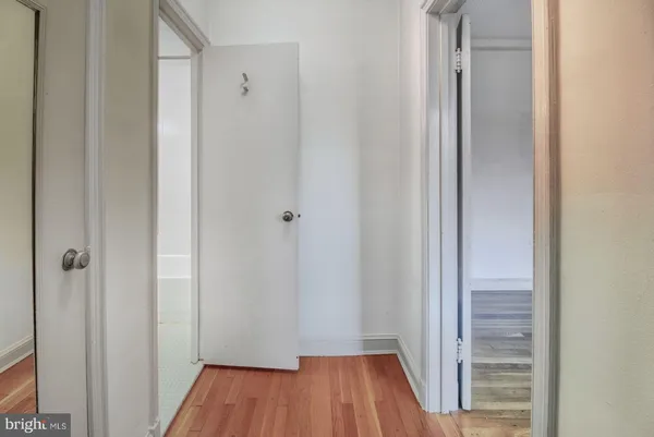 a view of a hallway with wooden floor