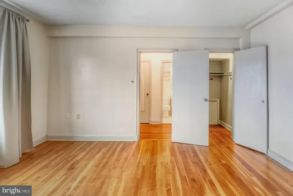 a view of hallway with wooden floor