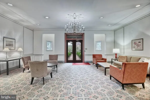 a living room with furniture a window and a chandelier