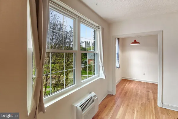 a view of a room with wooden floor and windows