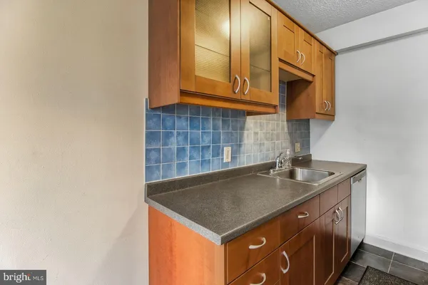a kitchen with stainless steel appliances a sink and a cabinets