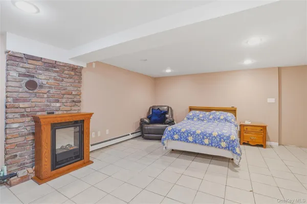 a bedroom with furniture and a fireplace