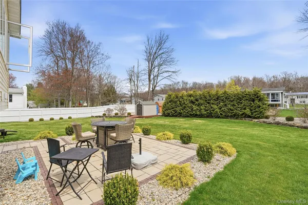 a view of a swimming pool and lounge chairs in the patio