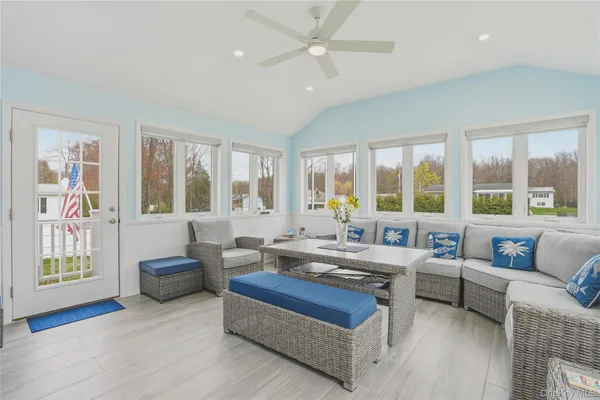 a living room with furniture and large windows