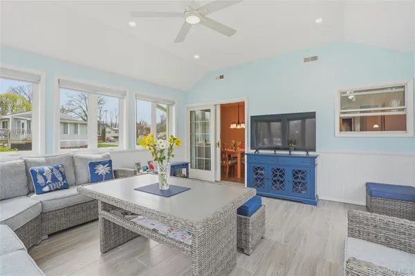 a living room with furniture and flat screen tv