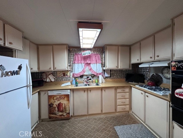 701 Montara Road, Unit 53 Barstow, CA 92311 - Photo 12 of 21 a kitchen with stainless steel appliances granite countertop a sink stove and refrigerator