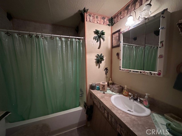 701 Montara Road, Unit 53 Barstow, CA 92311 - Photo 15 of 21 a bathroom with a sink a mirror and a shower
