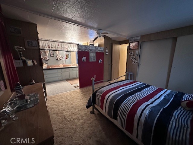 701 Montara Road, Unit 53 Barstow, CA 92311 - Photo 18 of 21 a bedroom with a bed and dresser with window