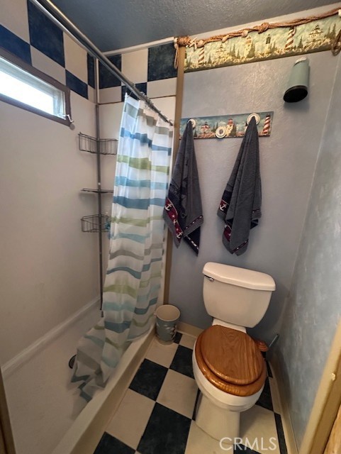 701 Montara Road, Unit 53 Barstow, CA 92311 - Photo 20 of 21 a bathroom with a toilet and a shower