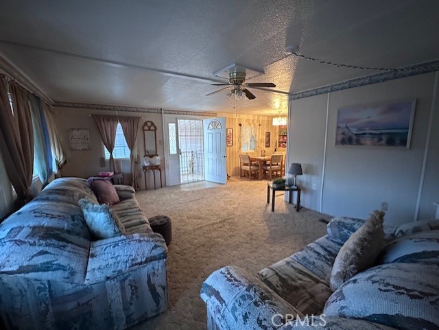 701 Montara Road, Unit 53 Barstow, CA 92311 - Photo 6 of 21 a living room with furniture and a large window