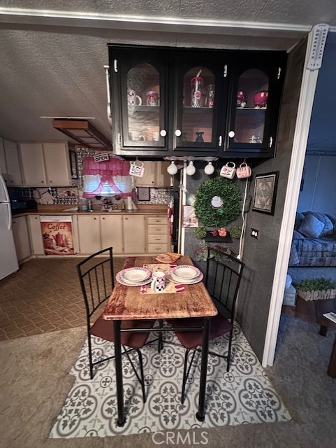 701 Montara Road, Unit 53 Barstow, CA 92311 - Photo 7 of 21 a kitchen with stainless steel appliances kitchen island granite countertop a table chairs and a wooden floor