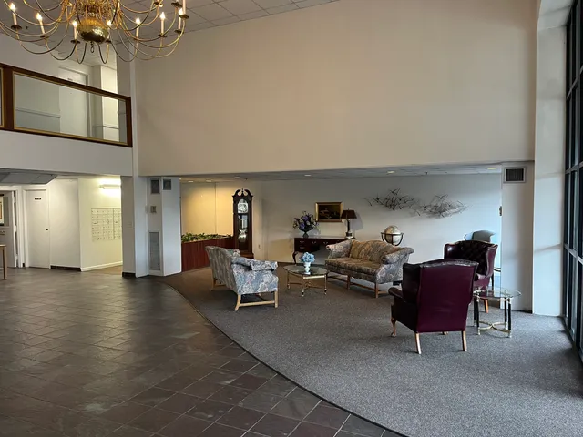a living room with furniture and a chandelier