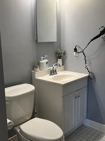 a bathroom with a sink a toilet and mirror