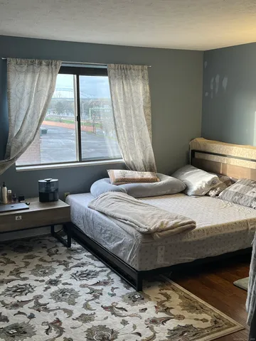 a bedroom with a bed and a window