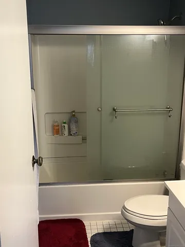 a bathroom with a toilet and a shower